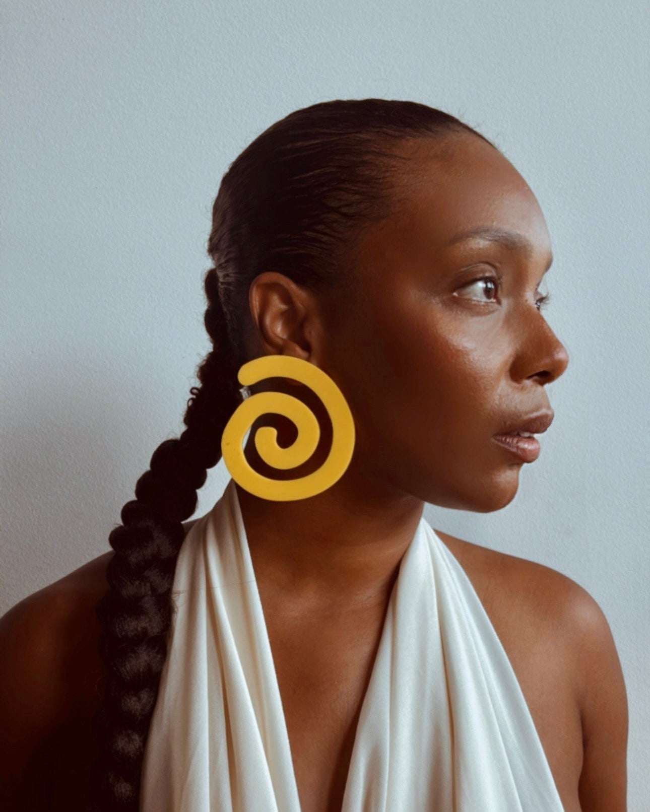 Ahsia yellow acrylic earrings by Cree & Company, worn view