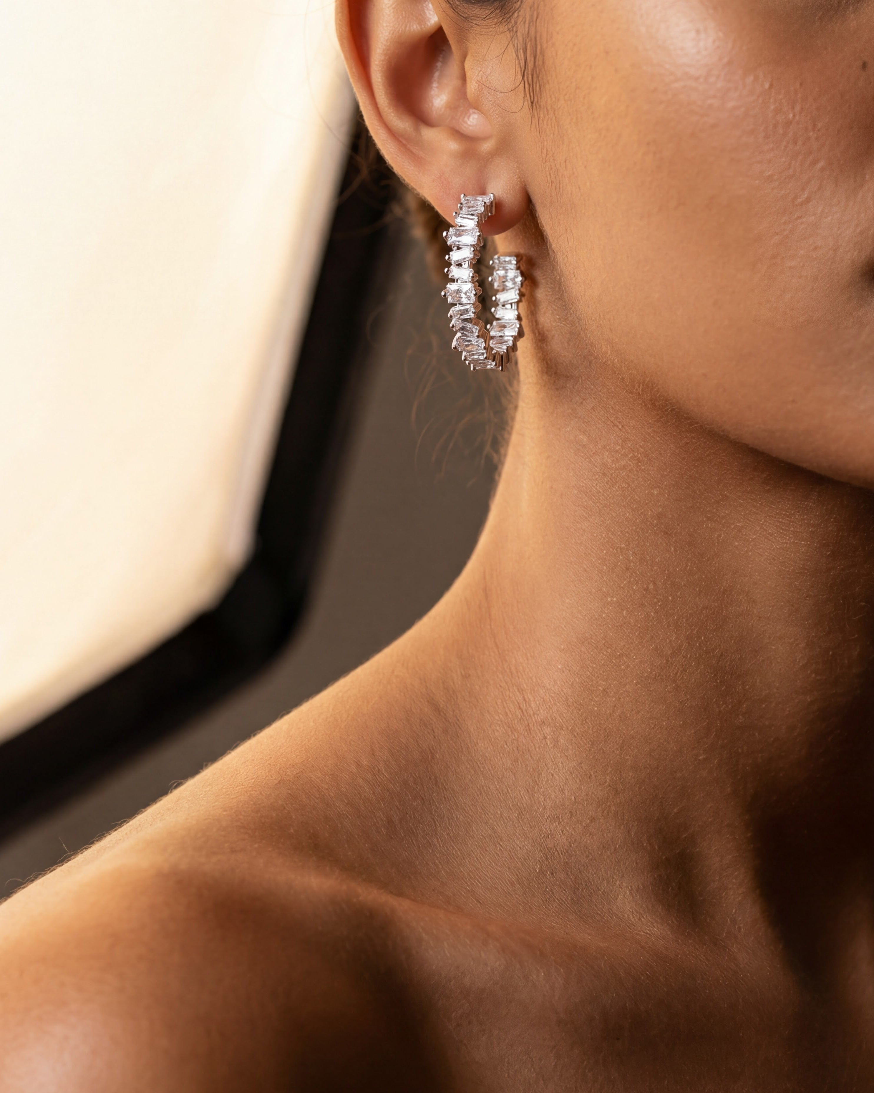 Close crop of the Clarity Hoop Earrings against skin, Ora Ana demi-fine jewelry