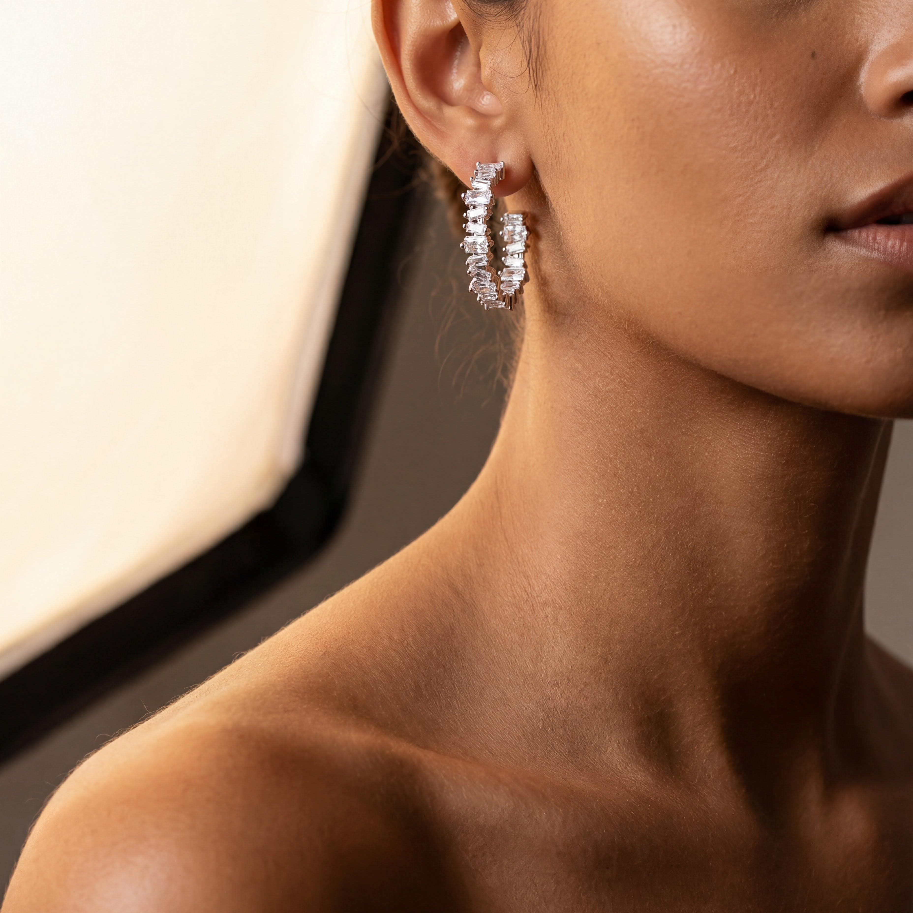 Close crop of the Clarity Hoop Earrings against skin, Ora Ana demi-fine jewelry