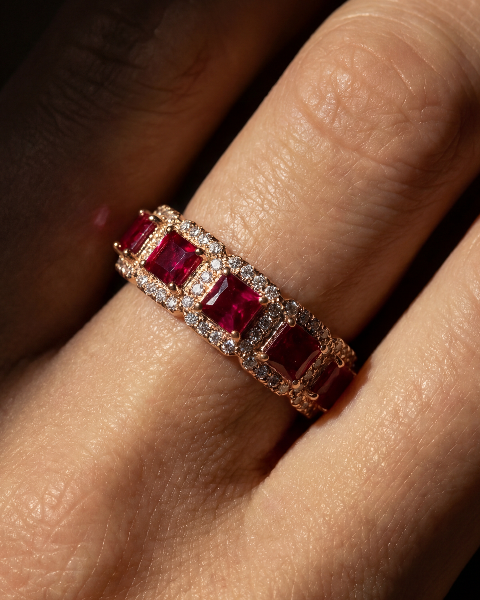 Crystalline Ring in rose gold with ruby toned stones, worn on the finger